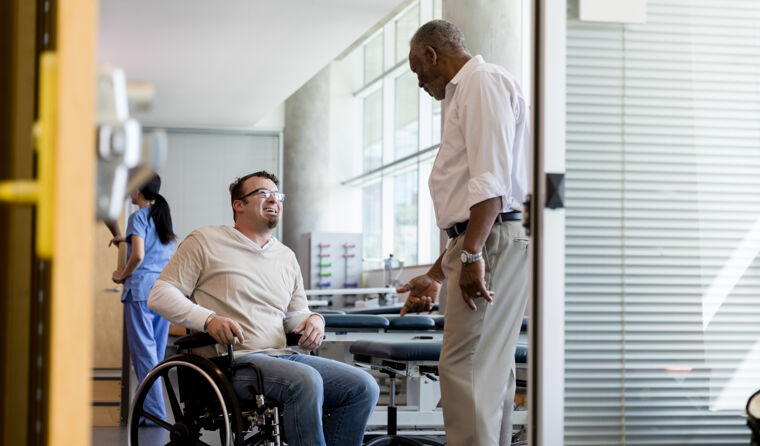 Man in wheelchair talking to doctor