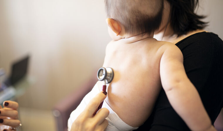 Stethoscope sitting on a baby's back.