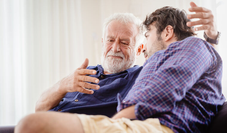 Older man have a heart-to-heart with a relative.