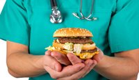 Doctor holding a hamburger.