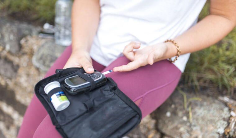 Person testing their own blood glucose