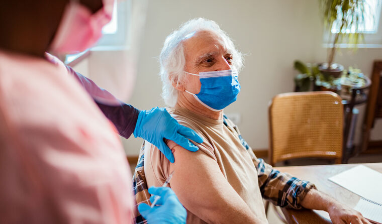 Elderly person being vaccinated against COVID