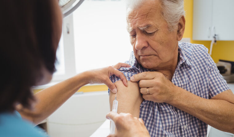 Older man getting a vaccine.