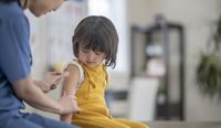 Toddler getting a flu vaccine. 