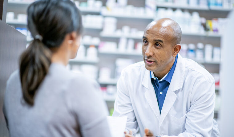 Pharmacist consulting with a patient. 