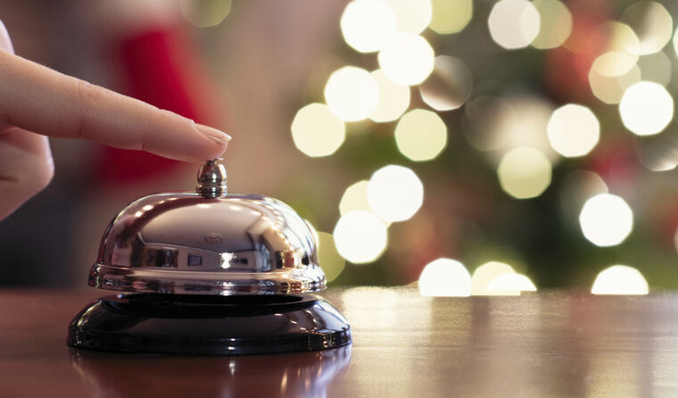 Hand with finger extended, ringing a desk bell