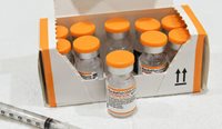 The children’s doses will be dispensed from orange-capped vials to differentiate them from adult doses. (Image: AAP)