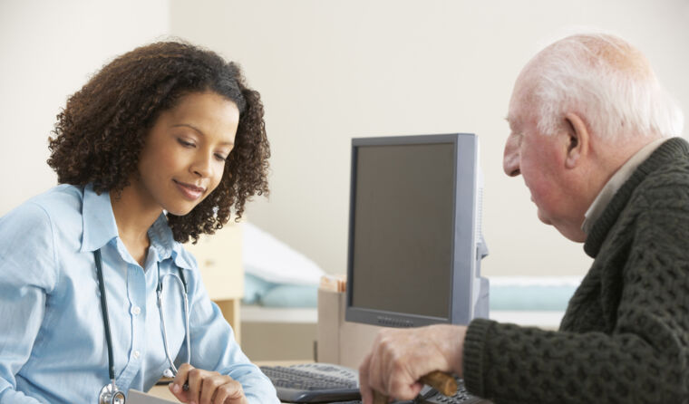 An older man speaking with a doctor.