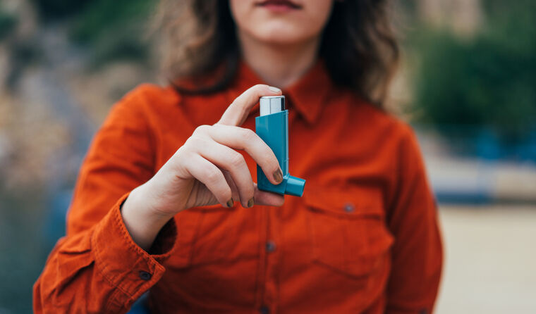 Young woman with asthma inhaler