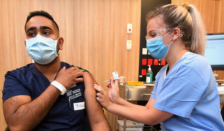 Nurse vaccinating man