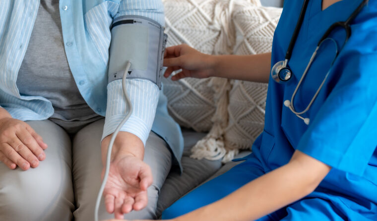 Doctor taking patient's blood pressure.