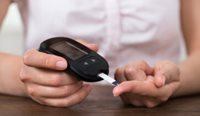 A person doing a finger prick test