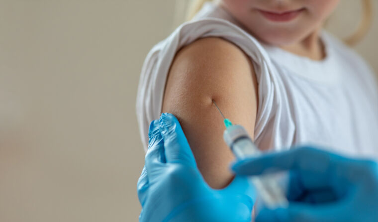 Child getting a vaccination in their arm. 