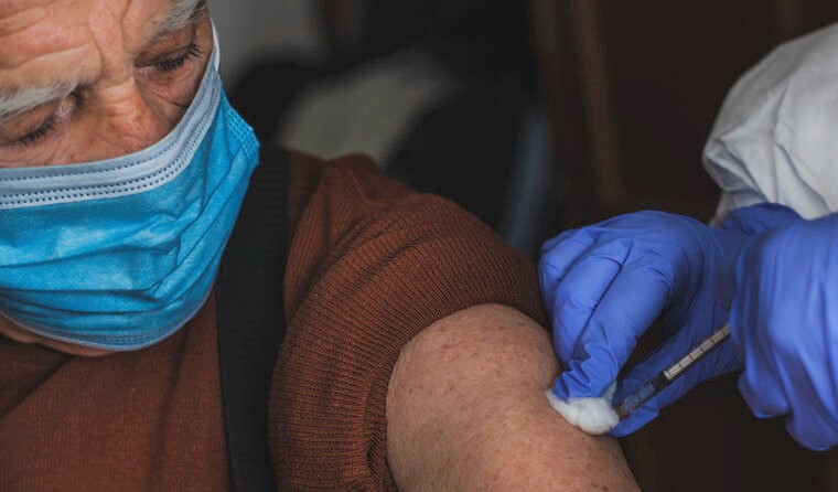 Elderly man receiving vaccine