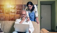 Confused south-Asian couple looking at laptop.