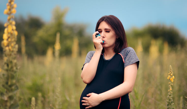 Pregnant woman using asthma puffer