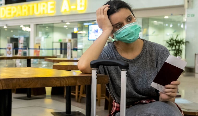Woman in mask waiting at airport