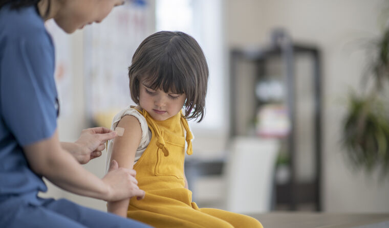Toddler getting a flu vaccine. 