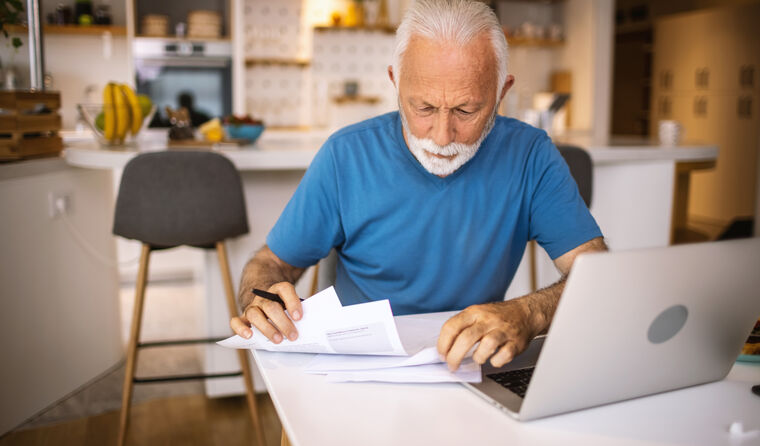 Older man sitting at computer.