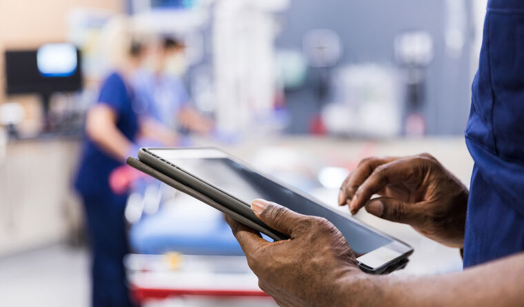 Doctor looking on iPad tablet