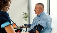 GP taking blood pressure