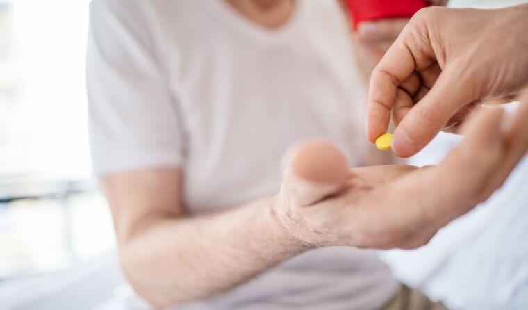 Person getting a pill put into their hand.