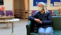Woman in face mask in waiting room