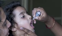 Child receiving oral polio vaccination.