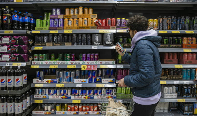 Man with beard shopping in soft drink aisle