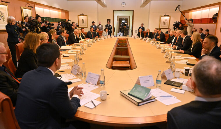 Big group of people sitting around a table. 