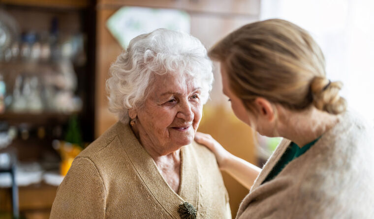 Elderly woman with carer