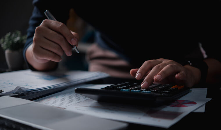 A person calculating financials.