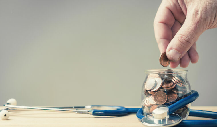 Coin going into a jar surrounded by stethoscope