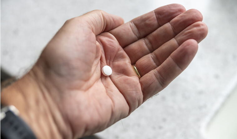 Hand holding pill