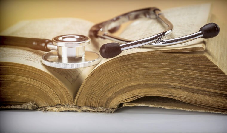 Old textbook and stethoscope