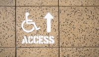 Wheelchair access sign on the footpath.