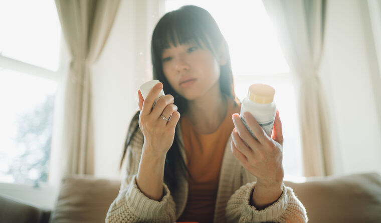 A person looking at medication label.