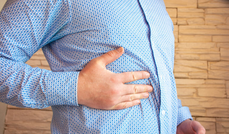 Person with pain in upper stomach