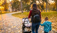 A mother and young child walking