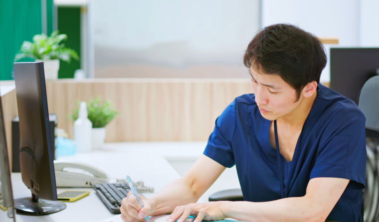 Doctor writing on a piece of paper.