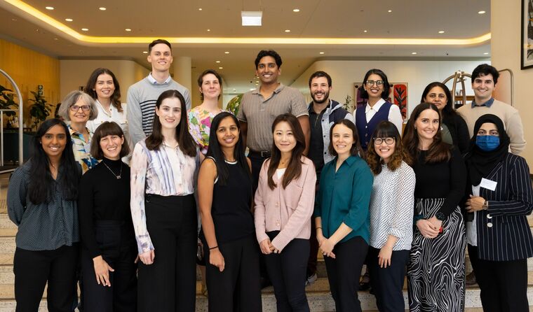 About 25 registrars pose for a group photo.
