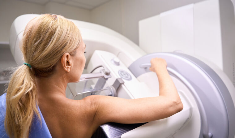 A female patient having a mammogram.