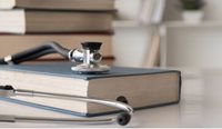 Stethoscope placed on top of medical text books.