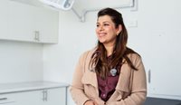 A doctor sitting in her consult room.