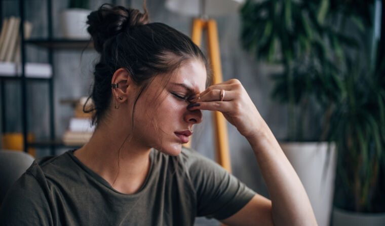 A woman holding her head in her hands