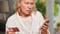 Woman looking at medication details on phone