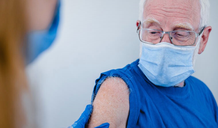 Elderly man receiving a vaccine