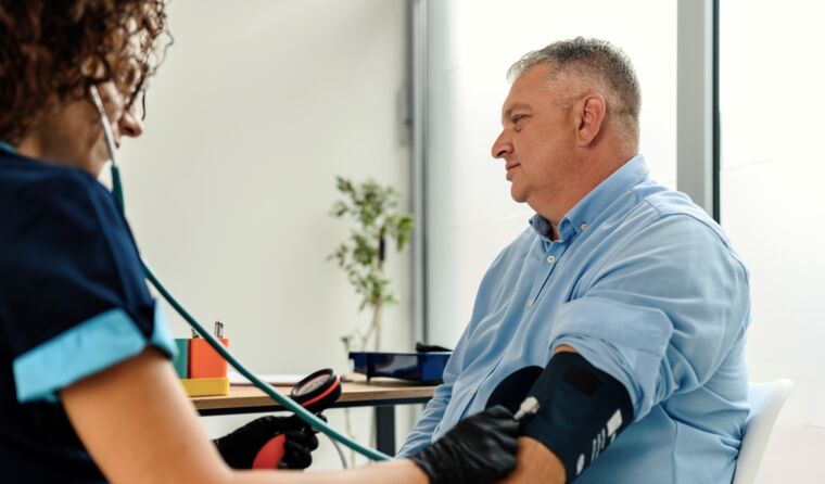 GP taking blood pressure