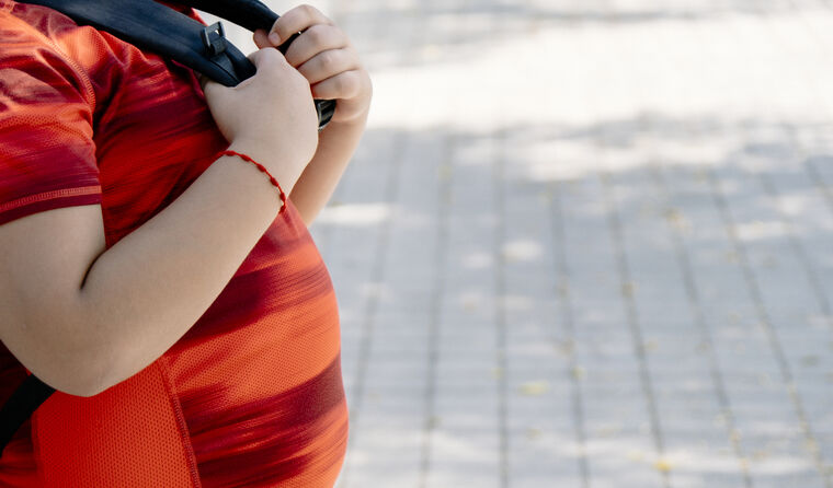 Young overweight boy with big belly.