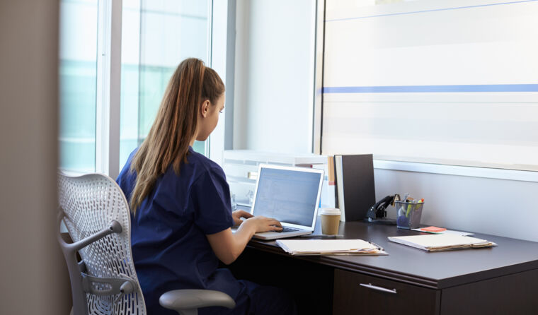 GP working at a computer.